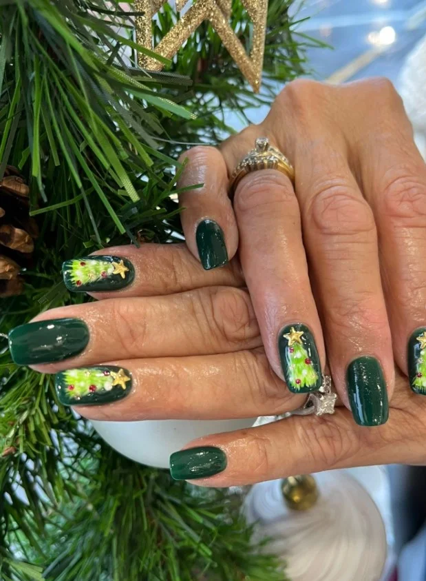 Cute Christmas nail designs featuring snowy evergreen trees for a peaceful winter manicure.