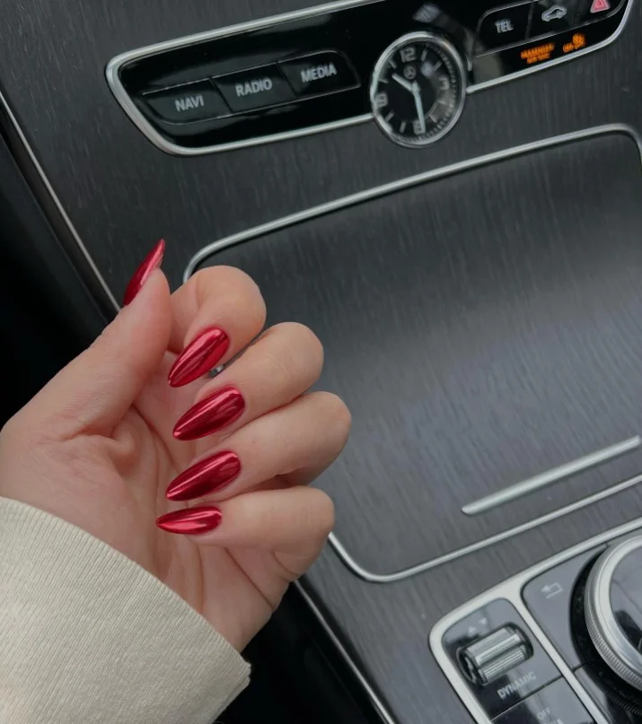 Cherry red glazed donut nail designs with a reflective mirror-like shine and glossy finish.