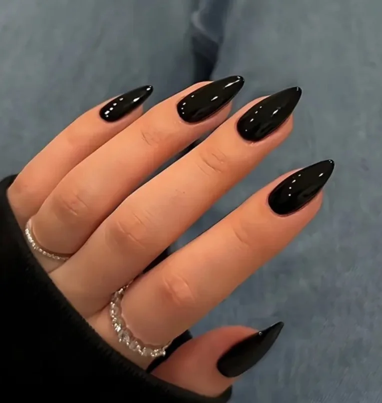 Glossy black nails styled with a navy blue evening dress.