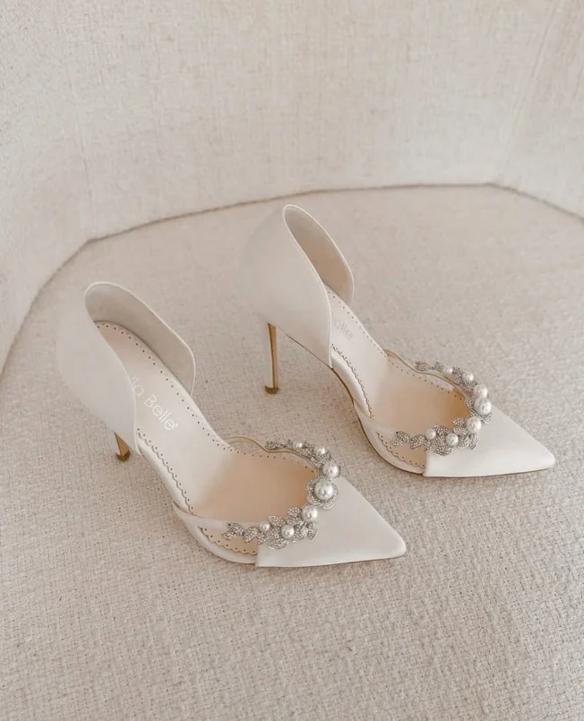 Ivory heels paired with a black dress for a daytime celebration.