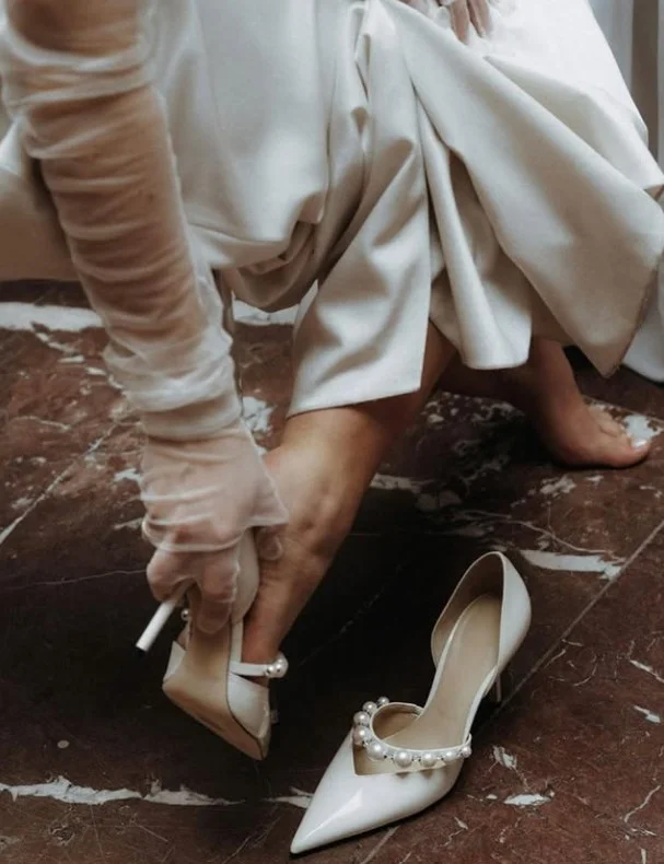 Soft ivory heels styled with a white dress for an elegant and seamless outfit.