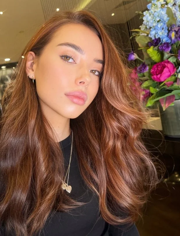 Light auburn hair combining warm brown and red tones for fair skin.