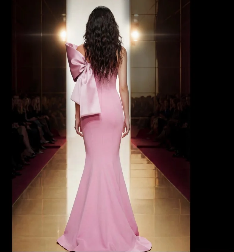 Light pink prom dress outfit with a satin bow back and elegant styling