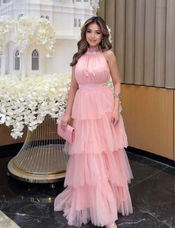 Light pink tiered tulle prom dress outfit with pearl heels