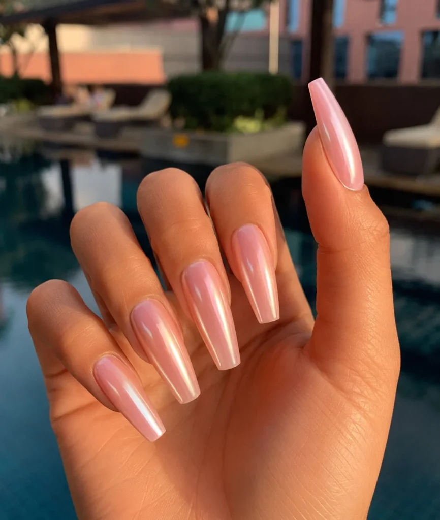 Long coffin nails finished with a glazed donut pearl shine for a glossy modern manicure.