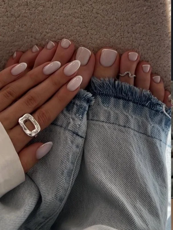 Matching manicure and pedicure featuring coordinated colors and complementary nail designs.