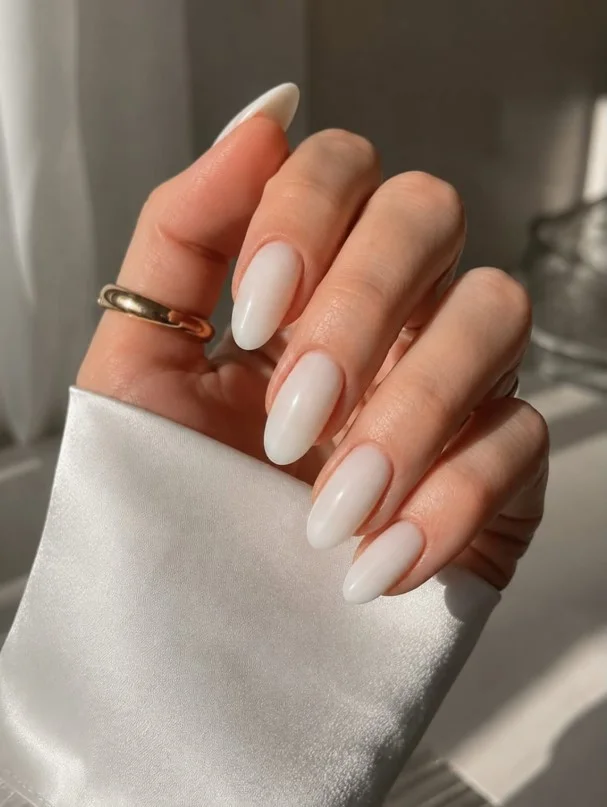 Milky white nails paired beautifully with an elegant purple dress.