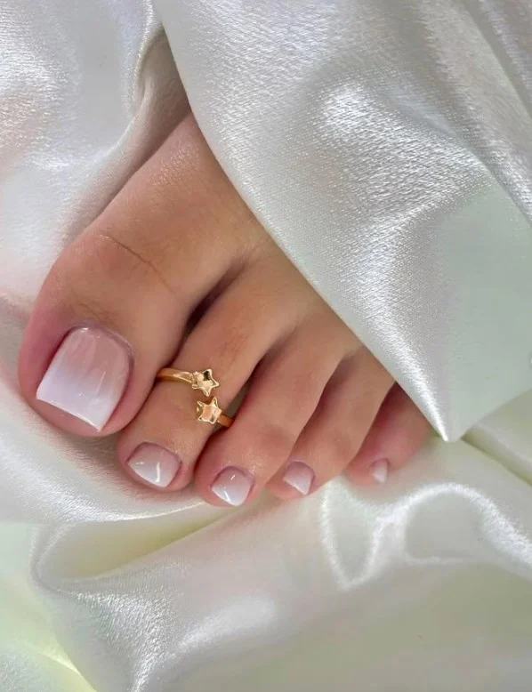 Ombré toe nail designs blending soft shades with a seamless gradient effect.