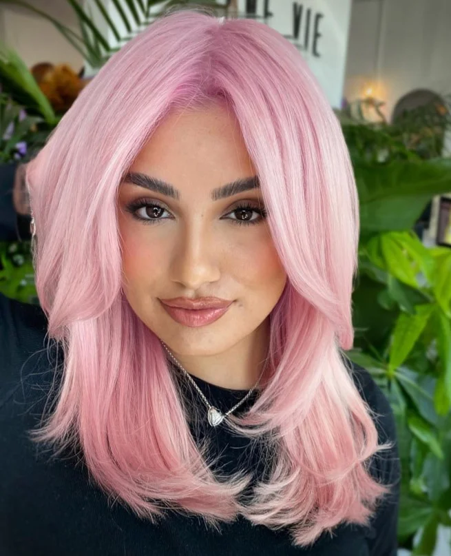 Wearable pastel pink hair creating a soft colorful look for fair skin.