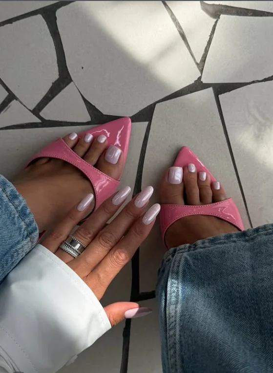 Pearl pink manicure creating a soft glow with a purple dress.