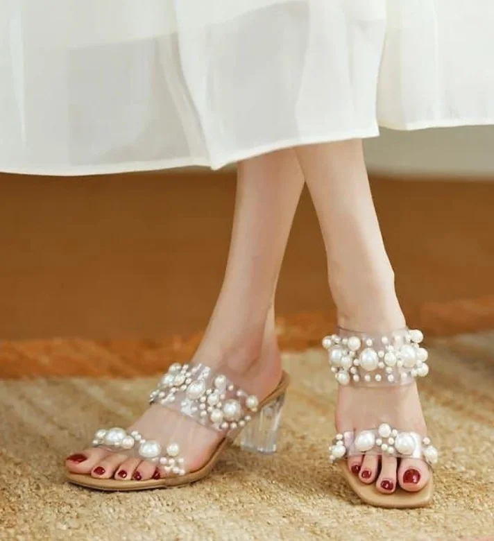 Elegant red dress styled with pearl white heels featuring delicate pearl details for a graceful occasion.