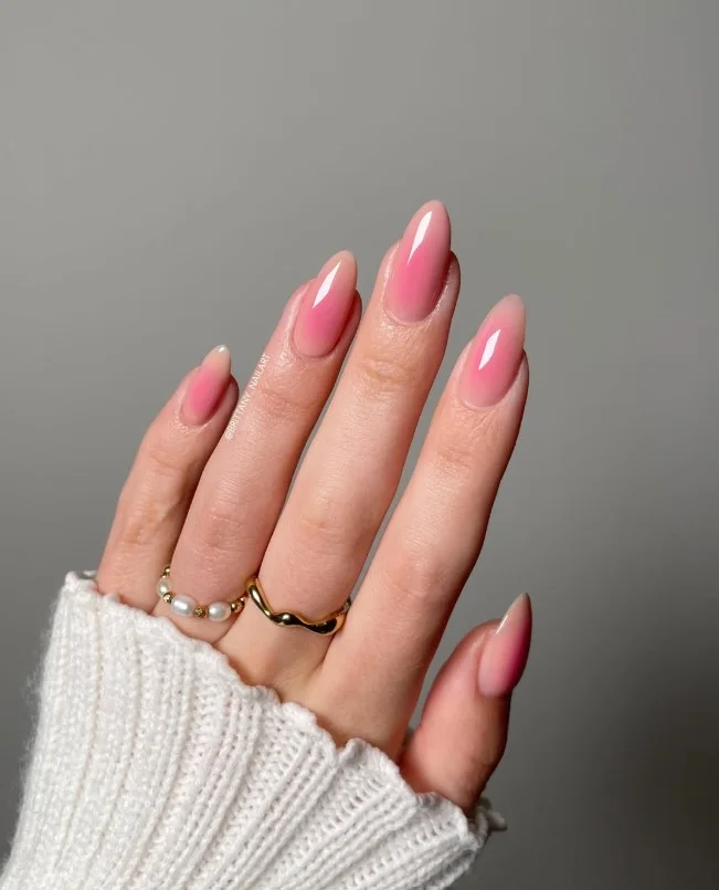 Pink aura glow nail designs blending soft pink over a sheer nude base with a subtle halo effect.