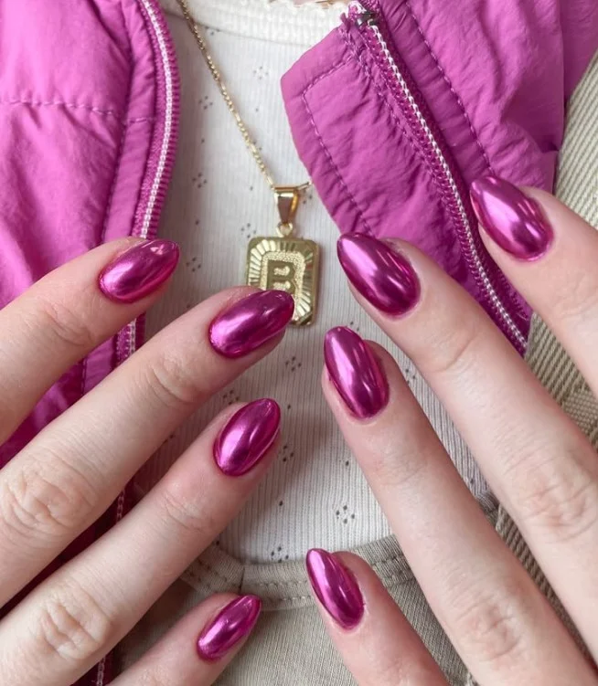 Pink chrome nail designs featuring a reflective mirror-like finish on long glossy nails.