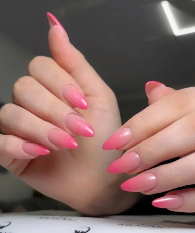 Pink ombré nail designs blending soft pink shades with a seamless glossy transition.
