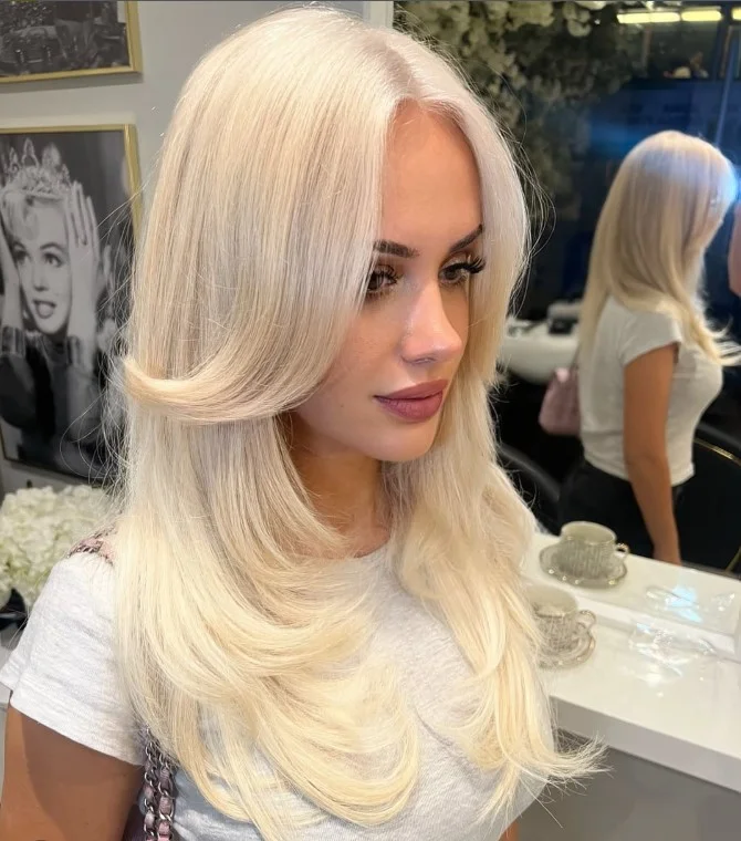 Bright platinum blonde hair complementing pale skin with cool pink undertones.