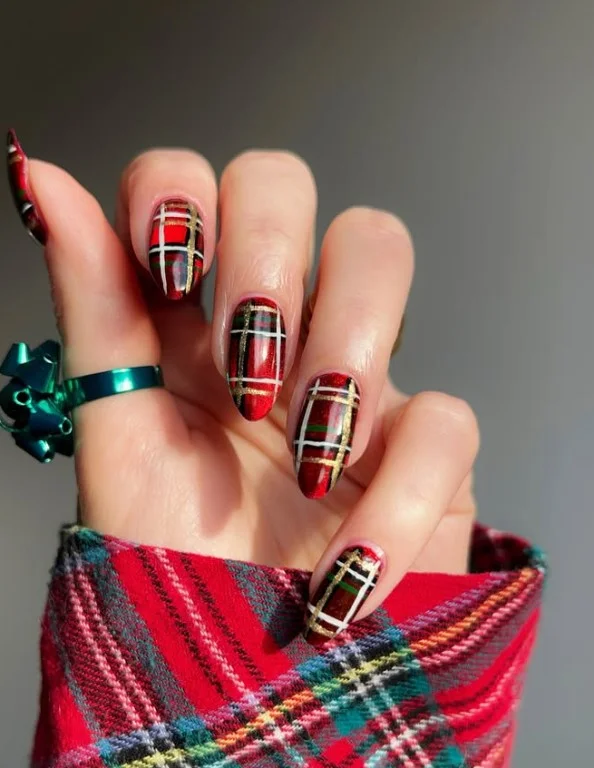 Cute Christmas nail designs with festive red and green plaid patterns accented by fine gold lines.