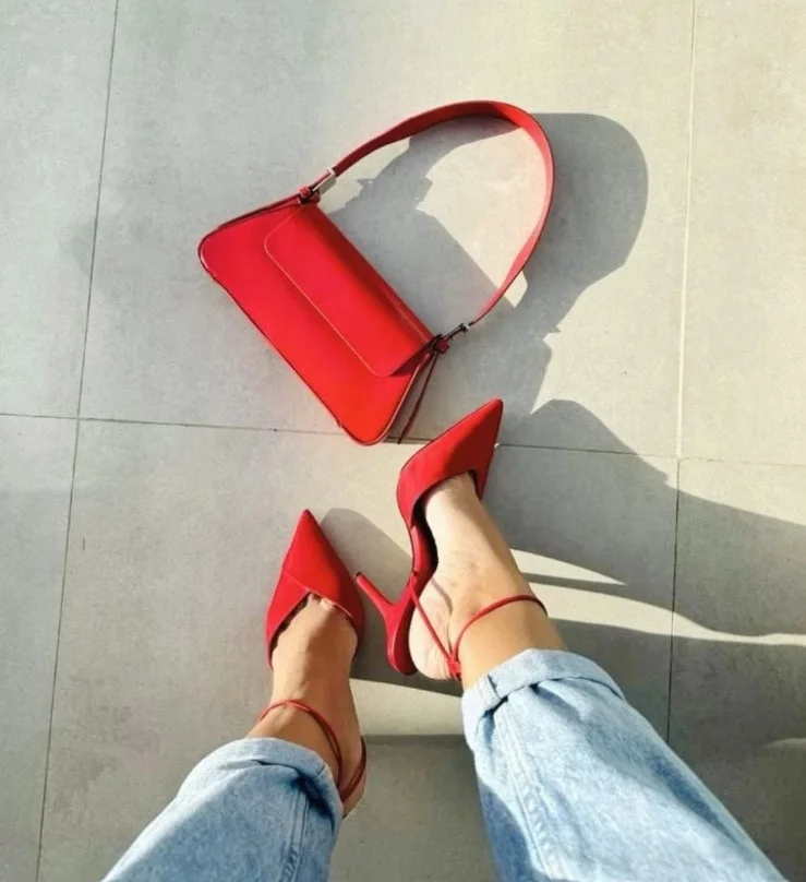 Black dress paired with elegant red heels for a romantic date night outfit.