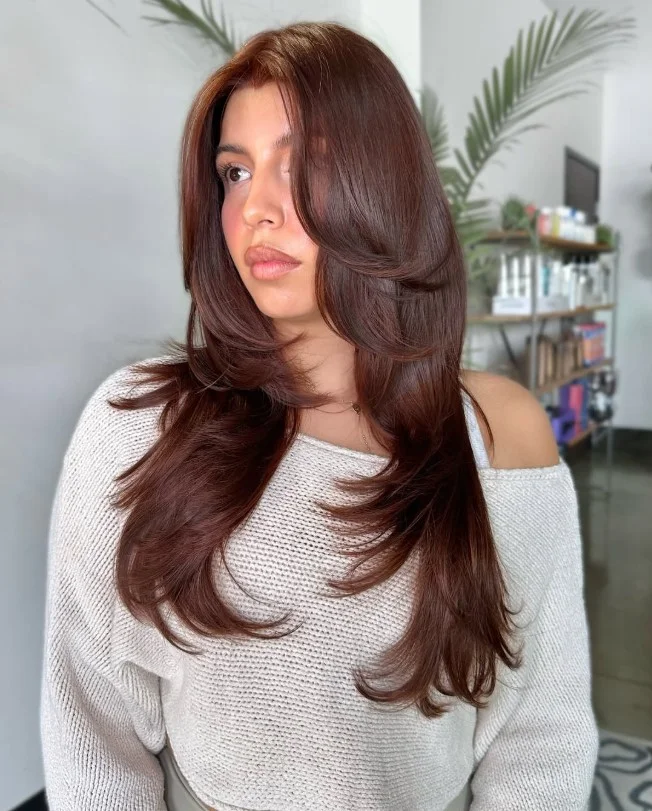 Rich chocolate brown hair creating elegant contrast against pale skin.