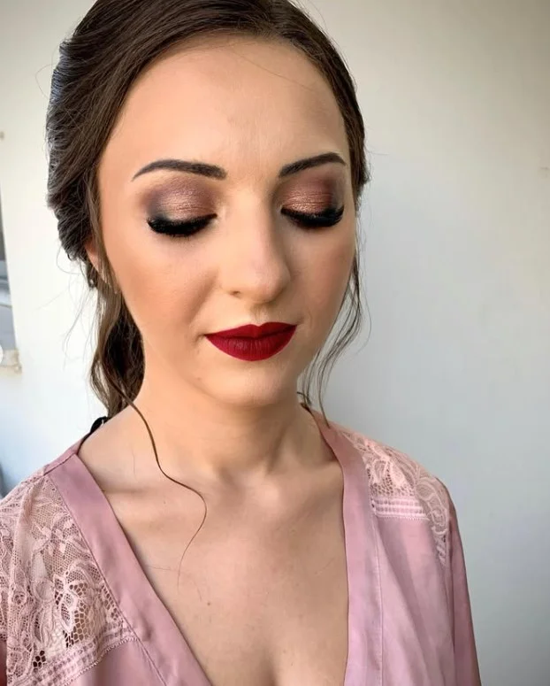 Rich wine red lipstick that creates an elegant evening makeup look for olive skin.