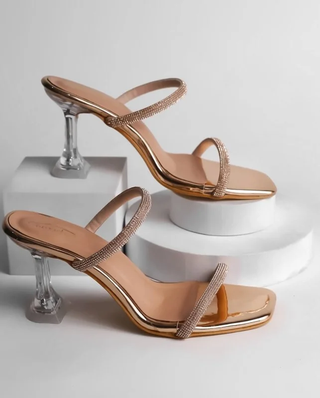 White party dress paired with rose gold ankle-strap heels for a feminine look.