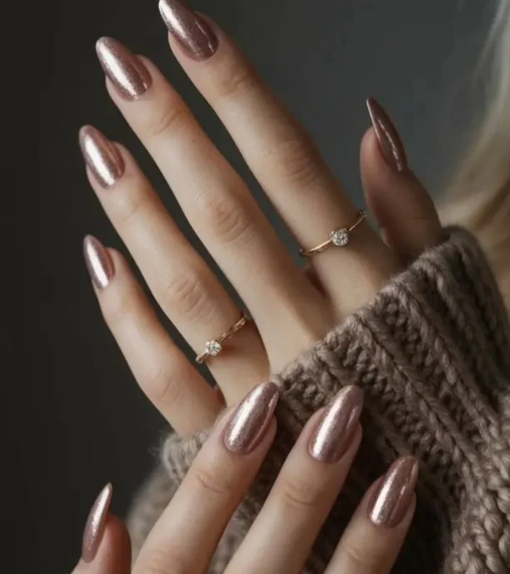 Rose gold manicure styled with a navy blue dress for an outdoor celebration.