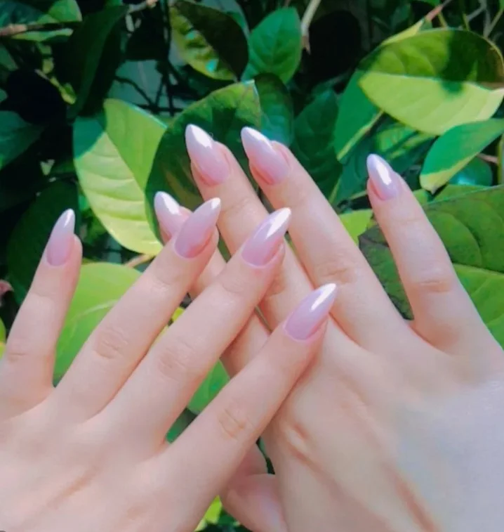 Natural sheer glossy nails complementing a green dress effortlessly.
