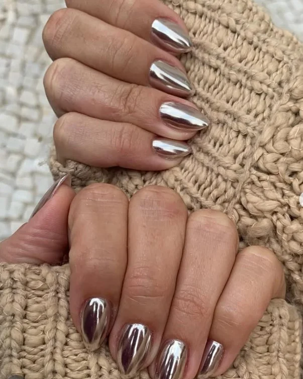 Silver chrome manicure styled with a navy blue evening dress.