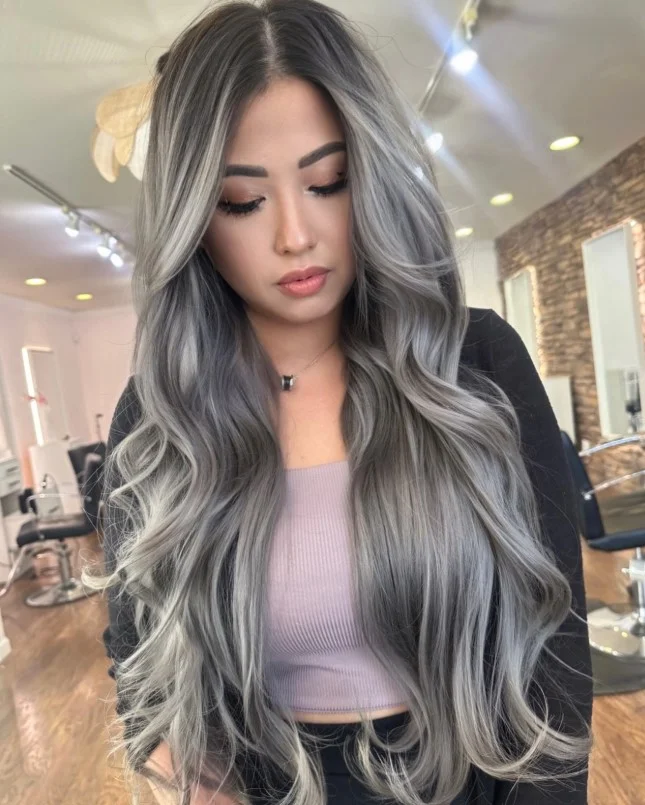 Silver hair with an icy metallic finish complementing cool pale undertones.