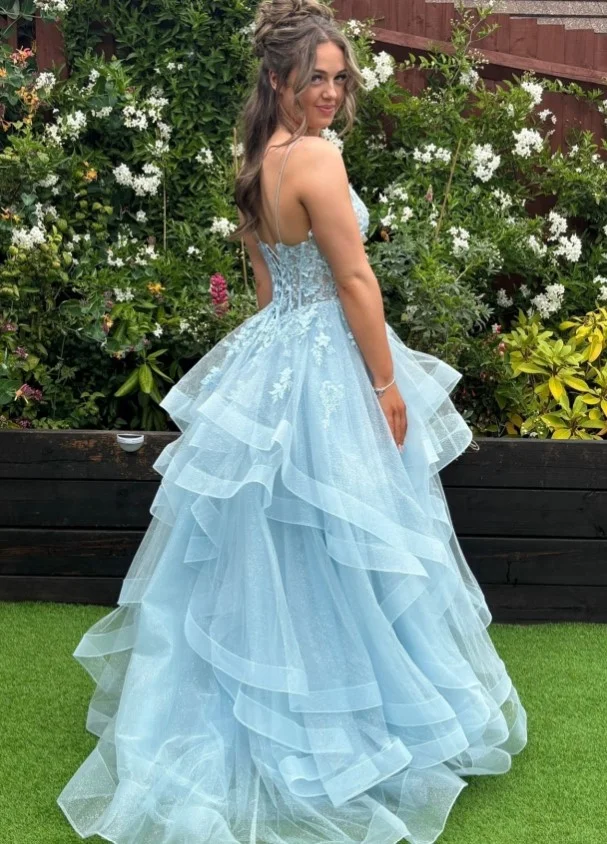 Sky blue prom dress with an elegant open-back design and sleek low bun