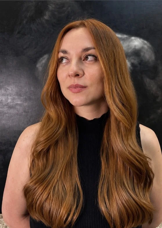 Soft copper hair adding warm color and brightness to a pale complexion.