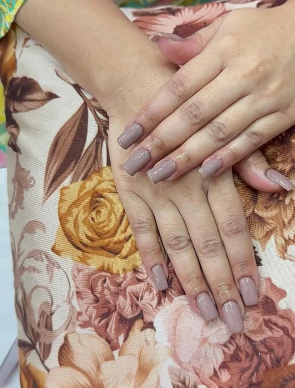 Soft grey manicure styled with a modern green dress outfit.