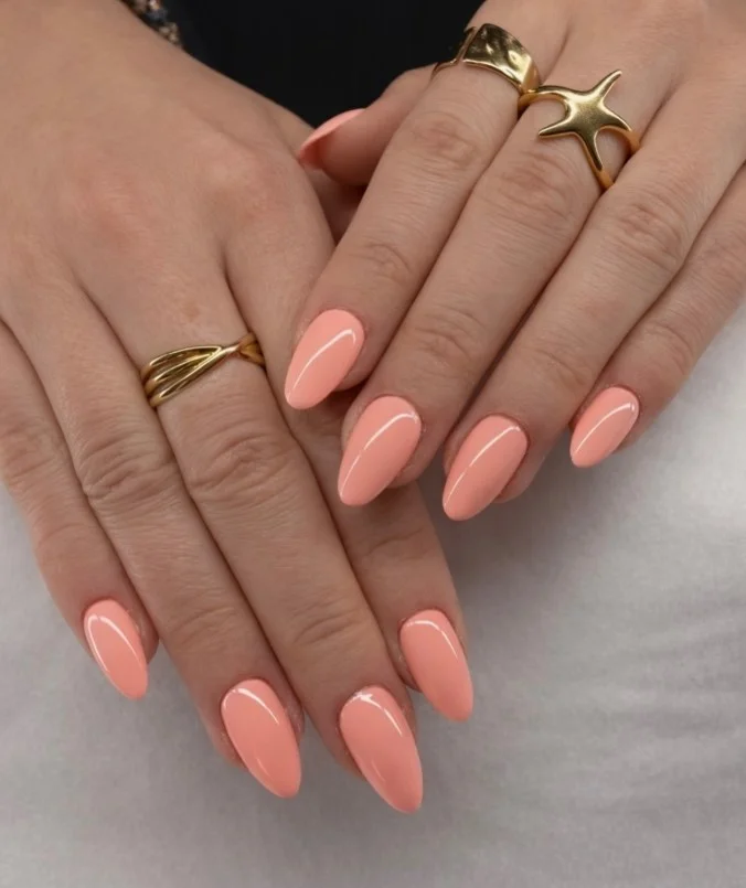 Soft peach nails adding warmth to a lavender dress outfit.