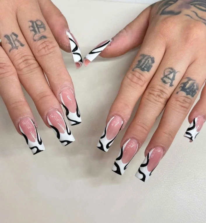 Square nail designs featuring elegant abstract line art on a glossy neutral base with minimalist details.