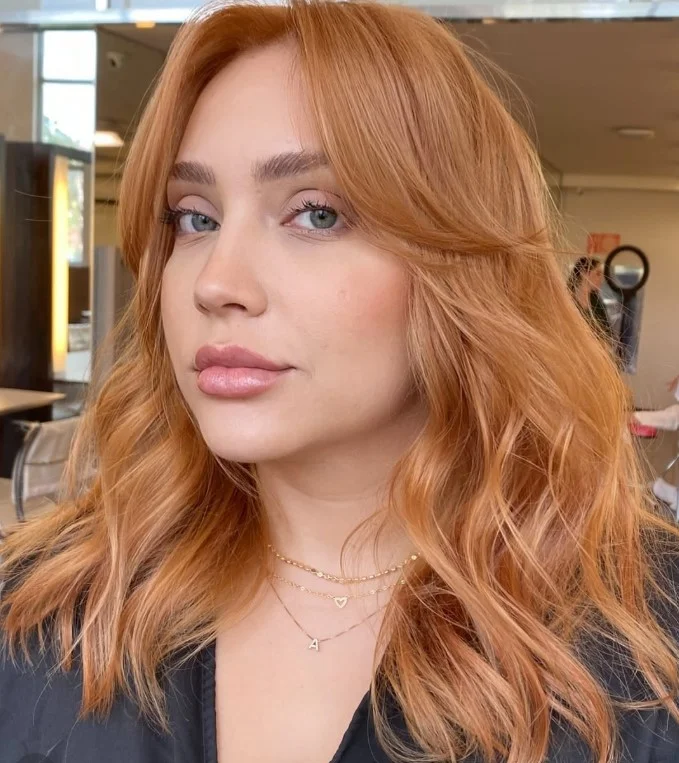 Strawberry blonde hair combining soft blonde and red tones for fair skin.