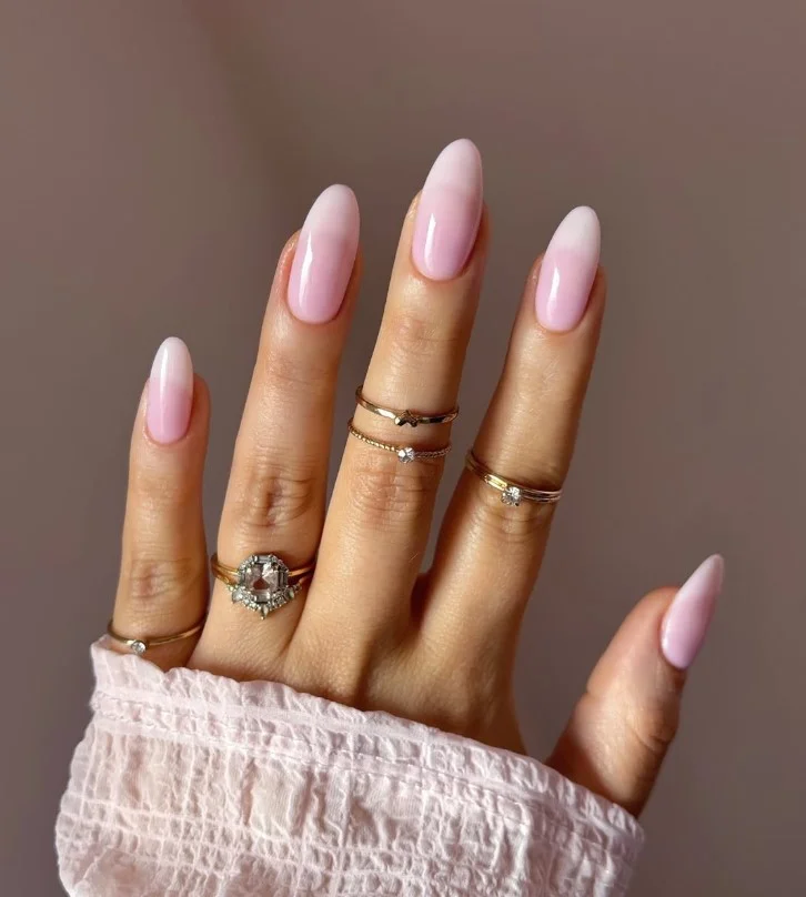 Strawberry milk pink nail designs with a creamy glossy finish creating a soft modern manicure.