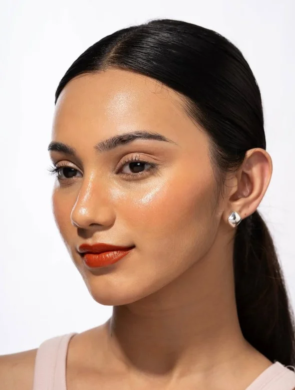 Burnt peach blush adding warm depth and definition to medium olive skin