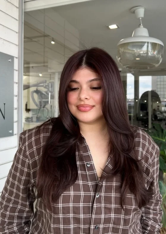 Cherry brown hair color adding a subtle red finish to deep brunette hair.