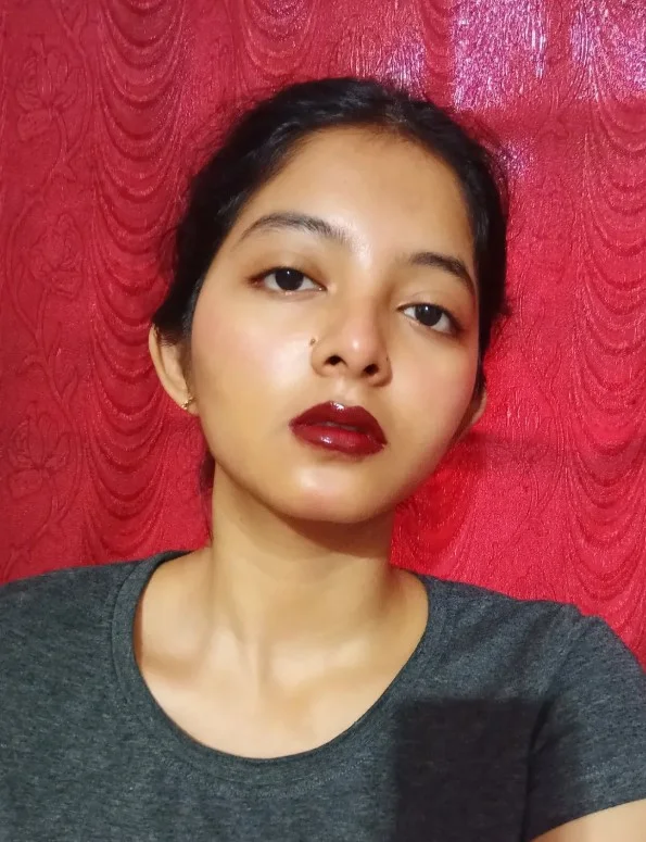 Cherry red lipstick creating a bold classic statement on fair skin.