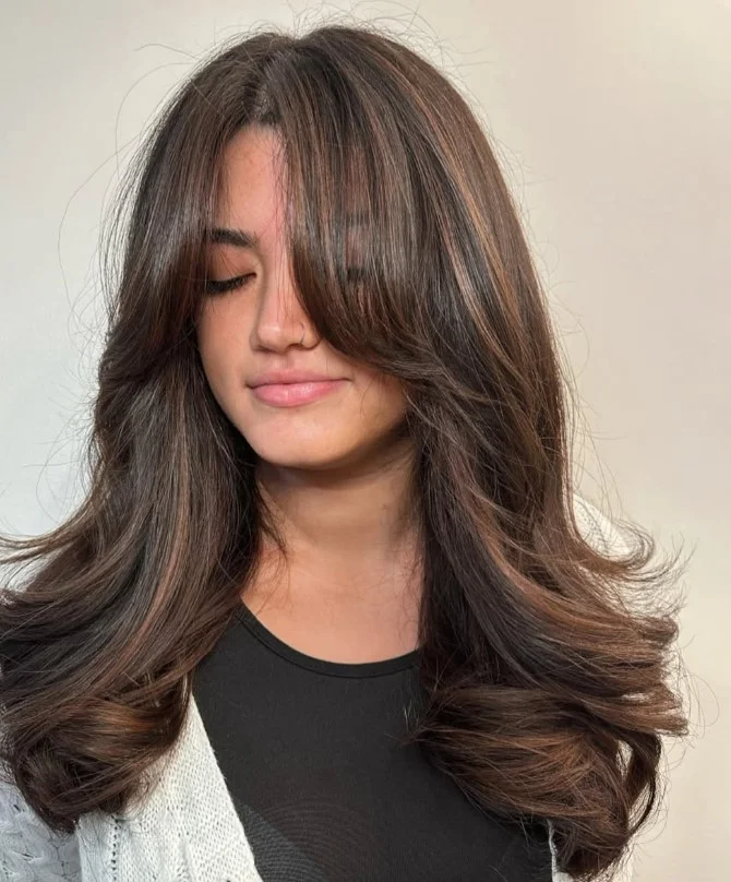 Rich chestnut brown hair creating a warm, natural look on red-toned skin.