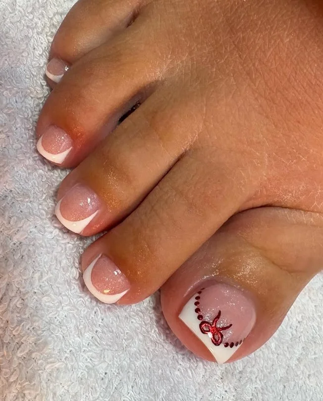 Christmas bow toe nails featuring delicate red bows on a neutral festive base