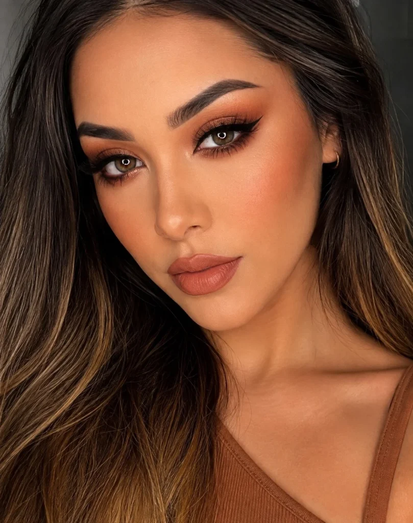 Cinnamon blush paired with warm makeup for a monochromatic olive skin look