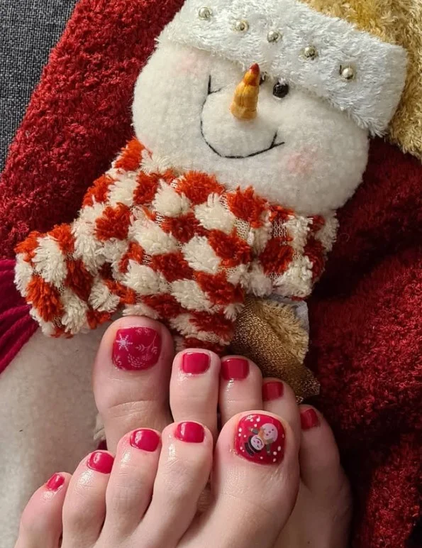 Classic red Christmas toe nails with glossy red polish on every toenail