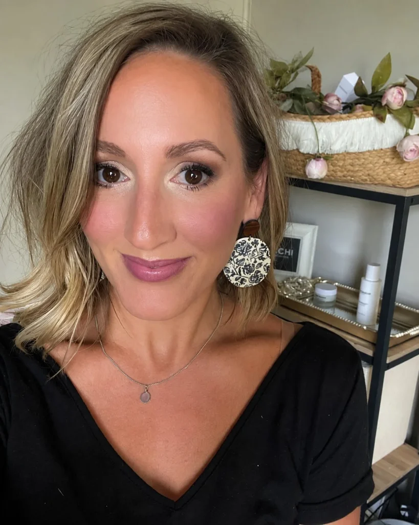 Dusty mauve blush complementing cool olive skin with a soft muted flush