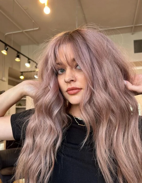 Dusty rose brown hair adding a subtle pink-brown tint to a polished brunette look.