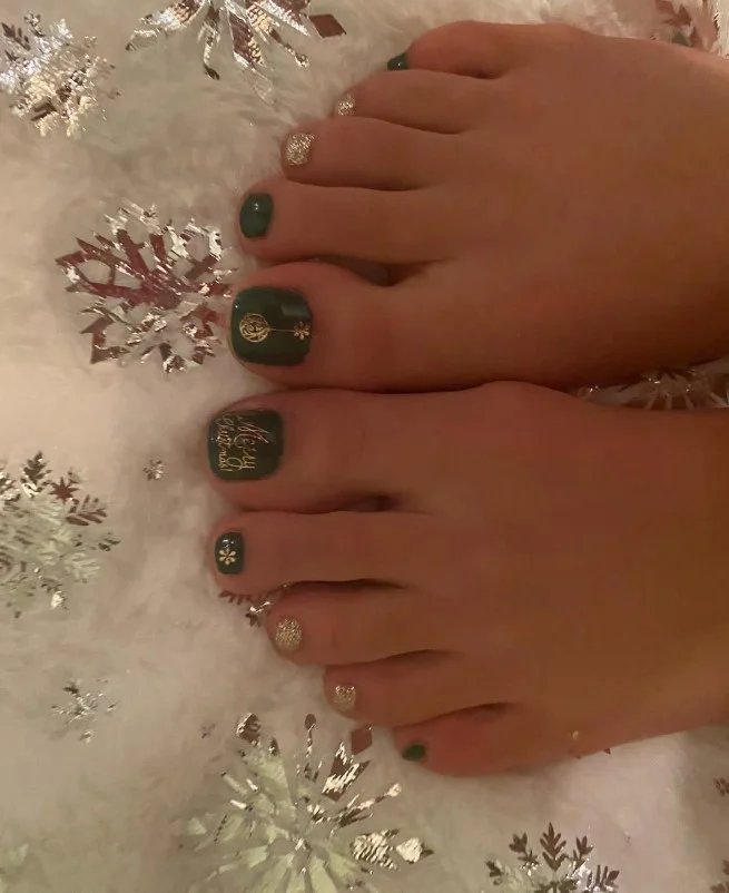 Gold Christmas toe nails with shimmering metallic gold polish and festive accents
