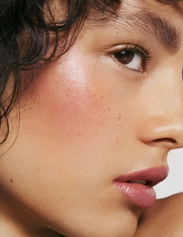 Muted rose blush creating an understated polished look on olive skin