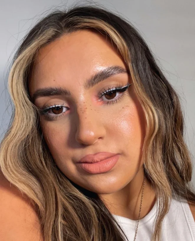 Peachy nude lipstick complementing warm fair skin with a natural finish.