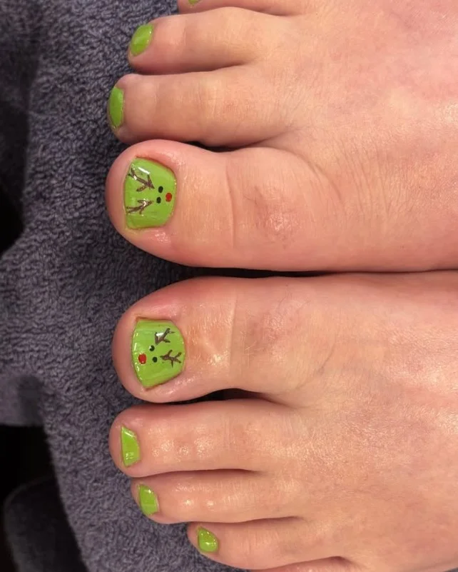 Reindeer toe nails featuring cute brown reindeer faces with festive Christmas details