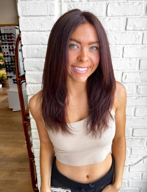 Rich auburn hair color styled to complement warm undertones and a red-toned complexion.