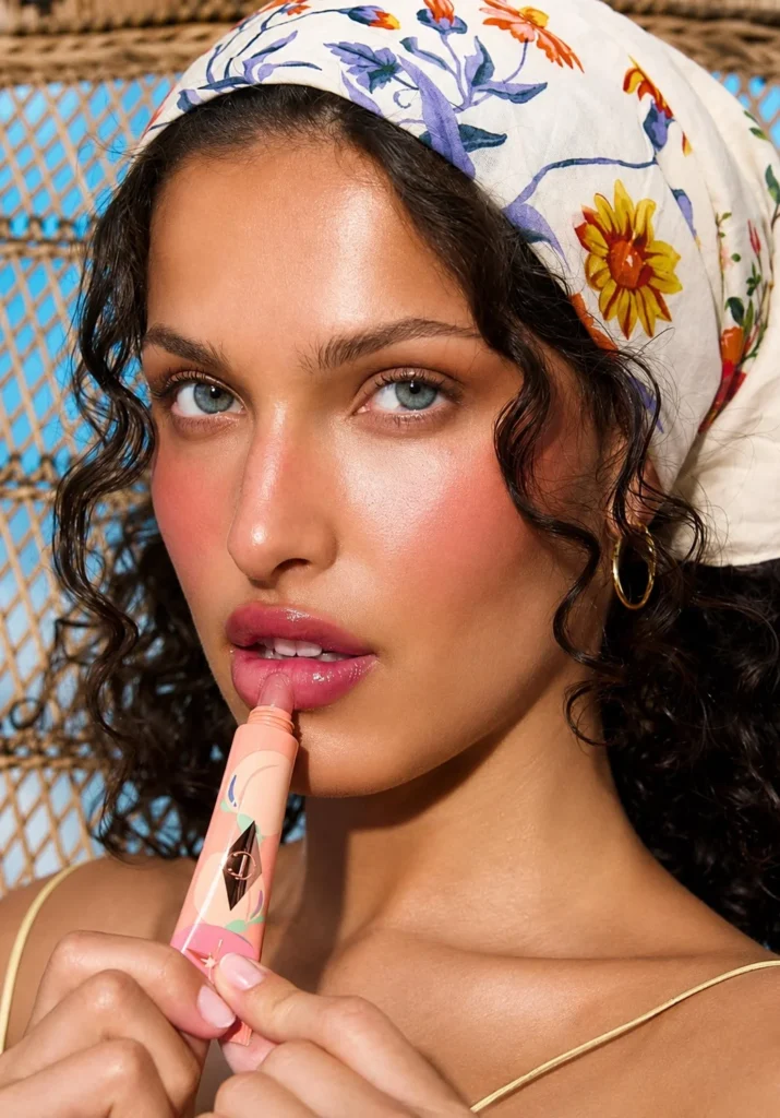 Sheer berry lip tint adding effortless natural color to fair lips.